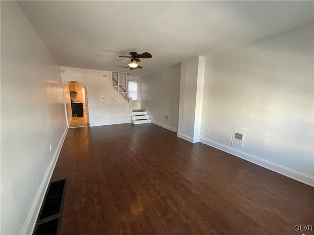 unfurnished living room with dark hardwood / wood-style floors and ceiling fan