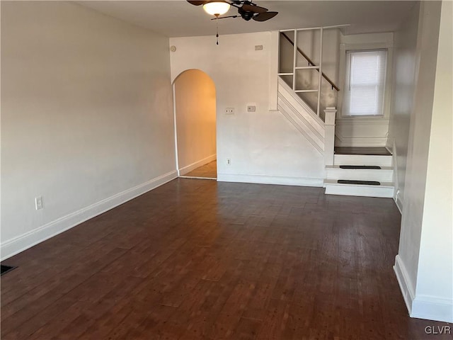 empty room featuring dark wood-type flooring and ceiling fan