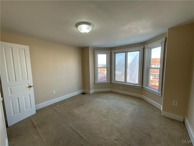 unfurnished room with light colored carpet