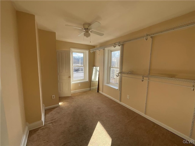 unfurnished room featuring light carpet and ceiling fan