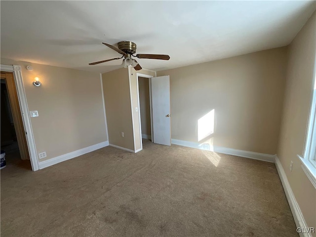 carpeted empty room featuring ceiling fan