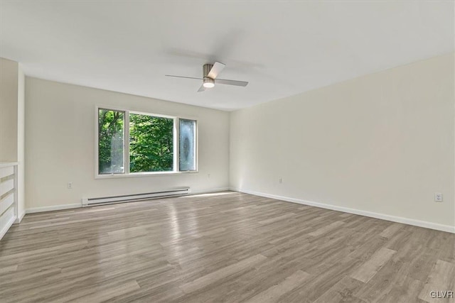 spare room with ceiling fan, light hardwood / wood-style floors, and a baseboard heating unit