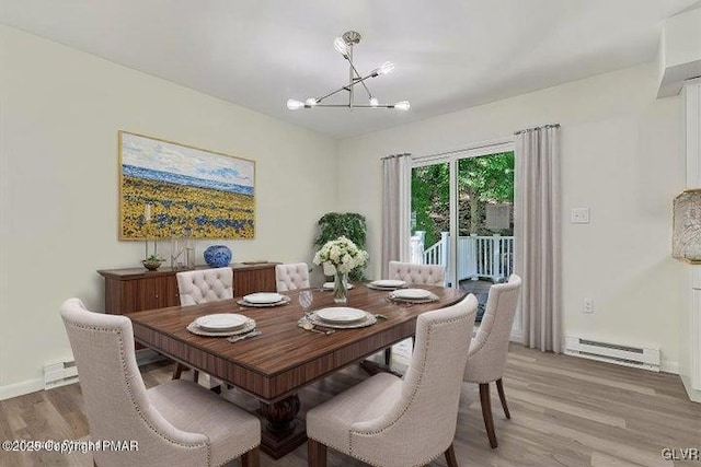 dining space with baseboard heating, a chandelier, and hardwood / wood-style floors