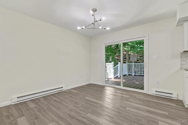 unfurnished dining area with a baseboard heating unit, a chandelier, and light hardwood / wood-style flooring