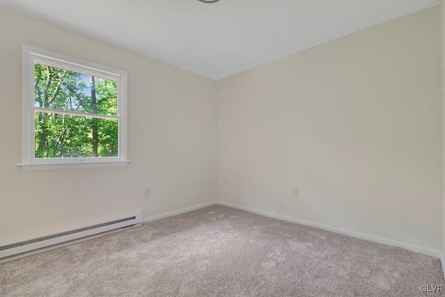 carpeted spare room featuring baseboard heating