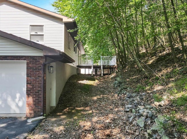 view of yard featuring a garage and a deck