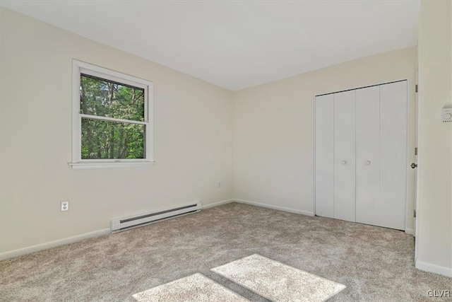 unfurnished bedroom with a baseboard radiator, light colored carpet, and a closet