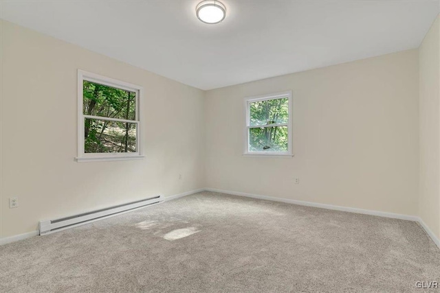 carpeted spare room featuring a baseboard radiator