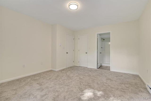 carpeted empty room with baseboard heating