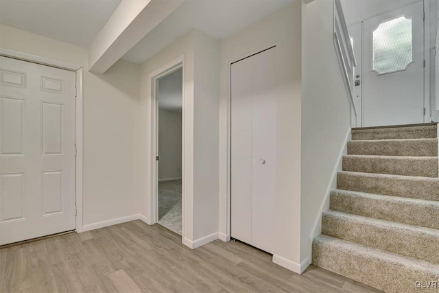 staircase with hardwood / wood-style flooring