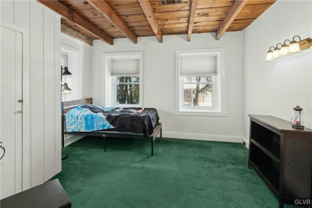 bedroom featuring beamed ceiling, dark carpet, and wood ceiling