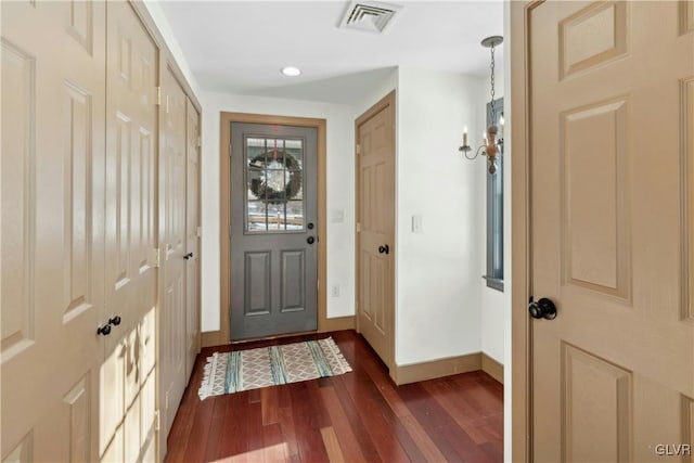 doorway to outside with dark wood-type flooring