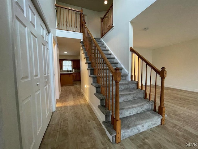 stairs with hardwood / wood-style floors