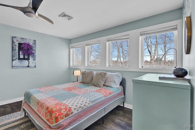 bedroom with ceiling fan and dark hardwood / wood-style flooring