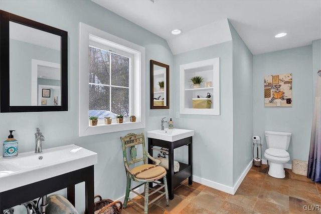 bathroom with built in features and toilet