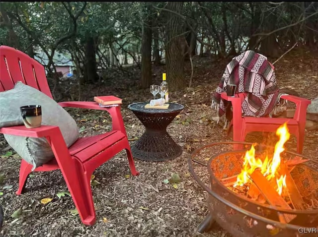 surrounding community featuring an outdoor fire pit