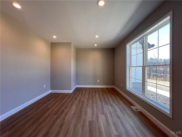 unfurnished room with a healthy amount of sunlight and light hardwood / wood-style flooring