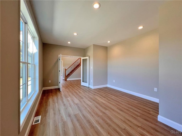 unfurnished room featuring light hardwood / wood-style flooring and plenty of natural light