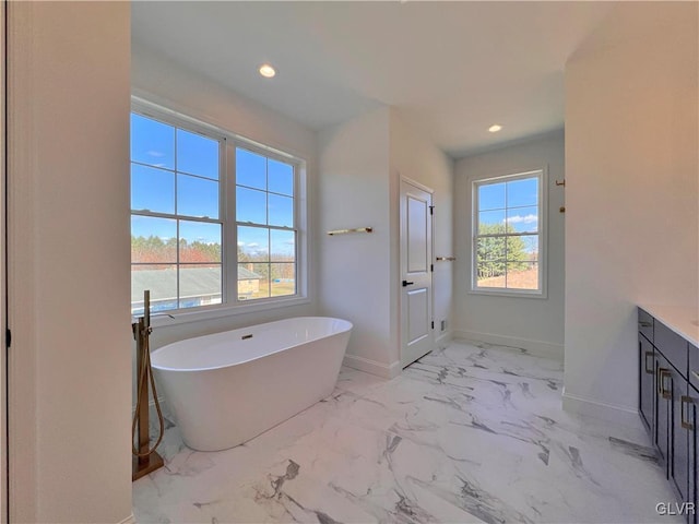 bathroom with vanity and a tub