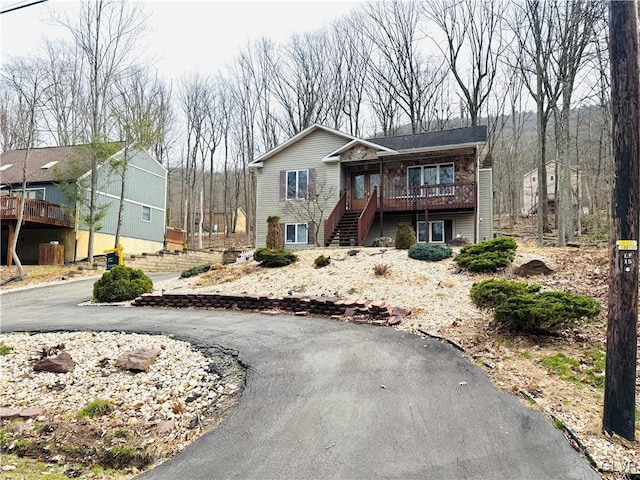 view of front of home with stairway and a deck