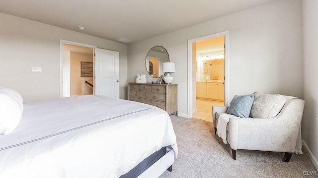 carpeted bedroom featuring ensuite bathroom