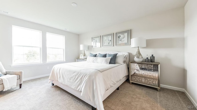 bedroom featuring light carpet