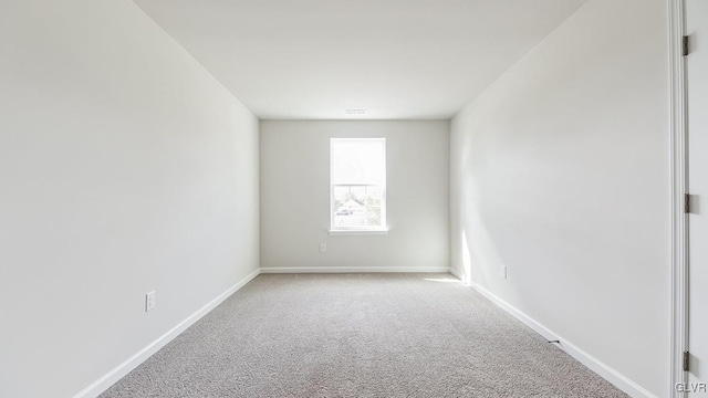 unfurnished room featuring light carpet