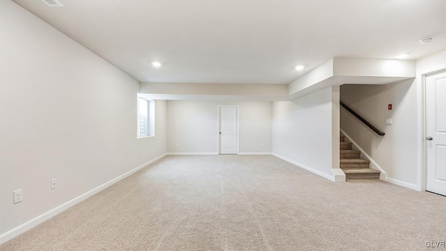 basement featuring light colored carpet