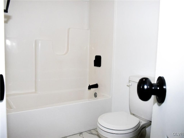 bathroom with shower / bathing tub combination and toilet