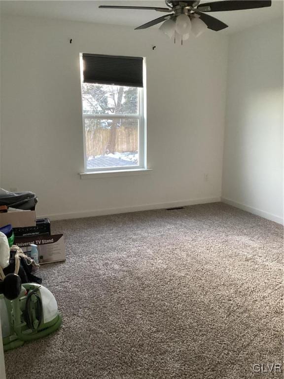 spare room featuring carpet flooring and ceiling fan