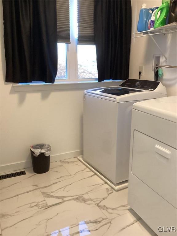 laundry room featuring separate washer and dryer