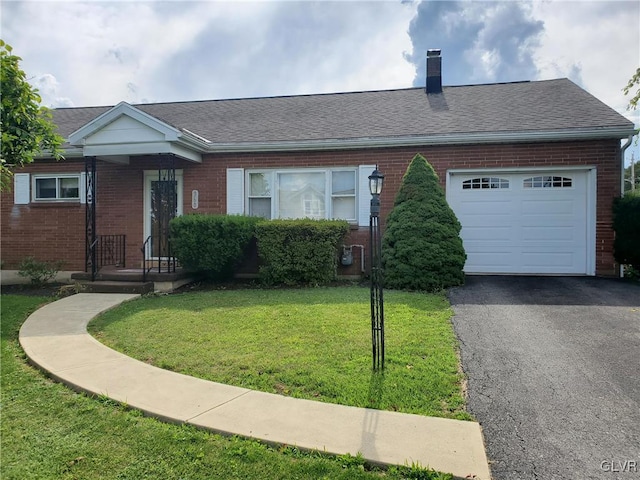 single story home featuring a garage and a front lawn