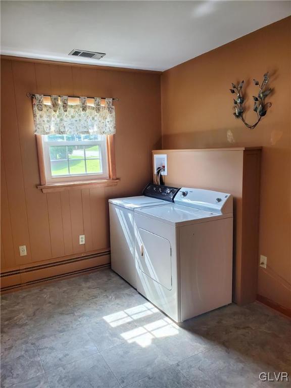 washroom featuring separate washer and dryer and a baseboard heating unit