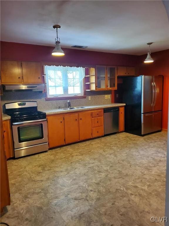 kitchen featuring appliances with stainless steel finishes, sink, and hanging light fixtures