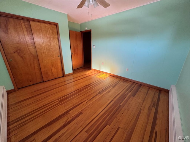 unfurnished bedroom with ceiling fan and light hardwood / wood-style floors