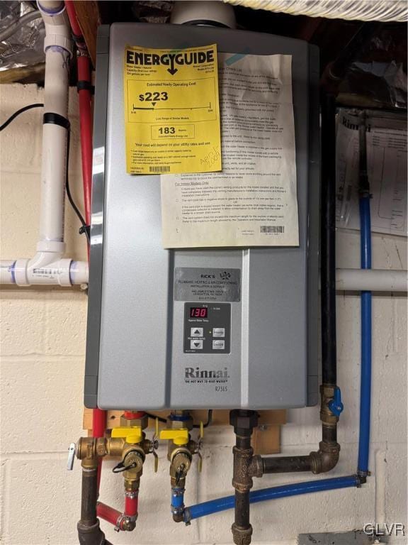 utility room featuring tankless water heater