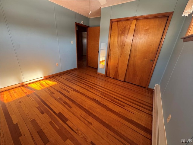 unfurnished bedroom featuring light hardwood / wood-style floors and a closet