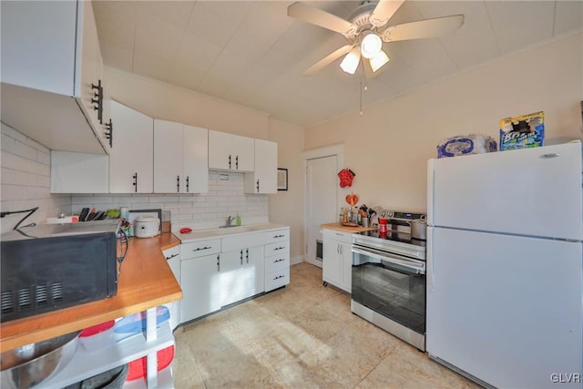 kitchen featuring white cabinets, decorative backsplash, freestanding refrigerator, stainless steel electric stove, and light countertops