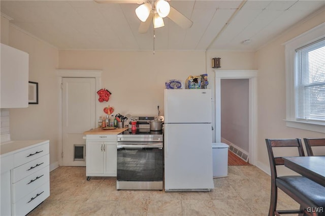 kitchen with ceiling fan, white cabinets, light countertops, freestanding refrigerator, and stainless steel electric range oven