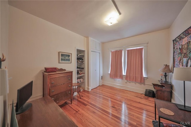 interior space with baseboards and light wood-style floors