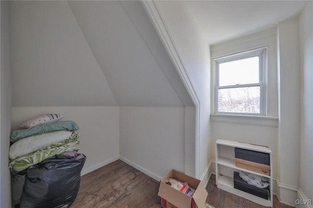 additional living space featuring lofted ceiling, baseboards, and wood finished floors