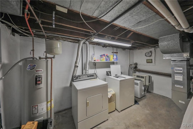 laundry room featuring laundry area, electric water heater, and washer and dryer