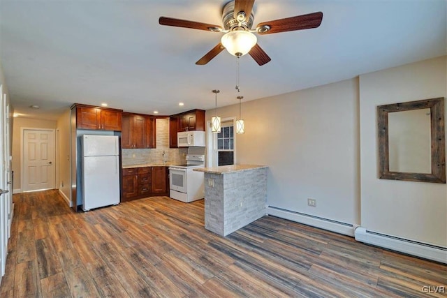 kitchen featuring white appliances, hanging light fixtures, a baseboard heating unit, tasteful backsplash, and dark hardwood / wood-style flooring