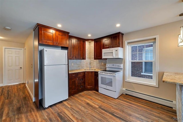 kitchen featuring sink, white appliances, dark wood-type flooring, light stone counters, and a baseboard radiator