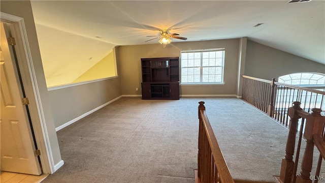 bonus room with vaulted ceiling, light colored carpet, and ceiling fan