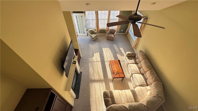 living room with ceiling fan and carpet flooring