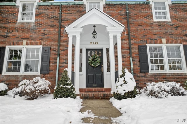 view of snow covered property entrance