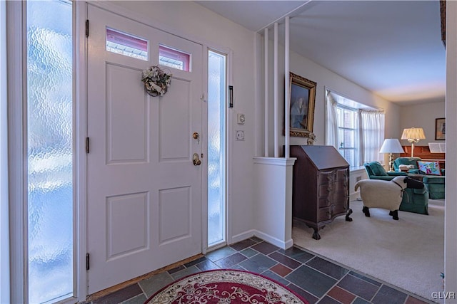 entryway featuring dark carpet