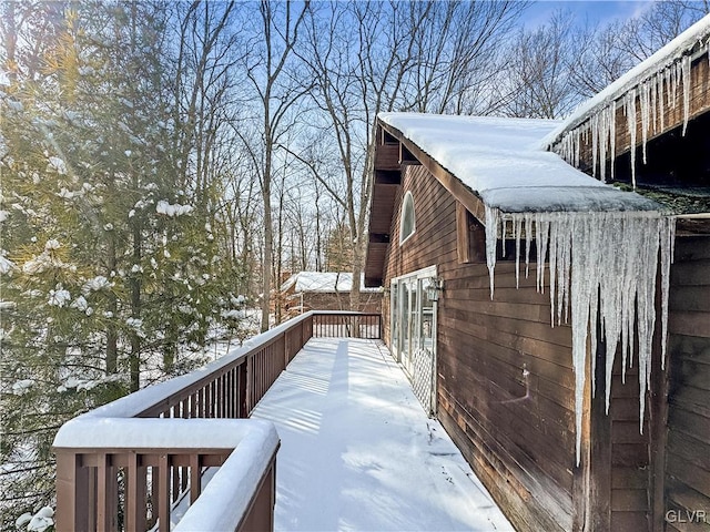 view of snow covered exterior with a wooden deck