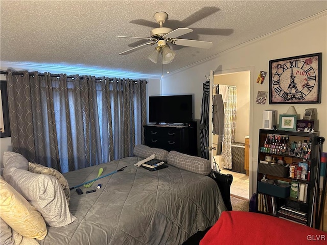 bedroom featuring crown molding, ensuite bathroom, a textured ceiling, and ceiling fan